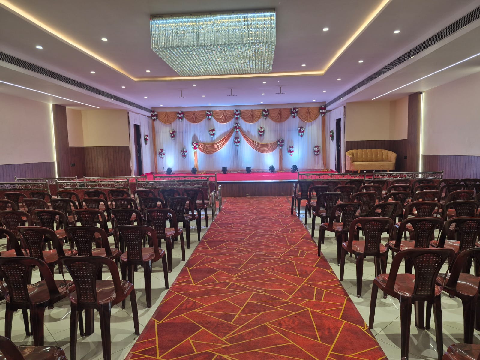 Stage decoration with soft drapes, floral accents and stage lighting