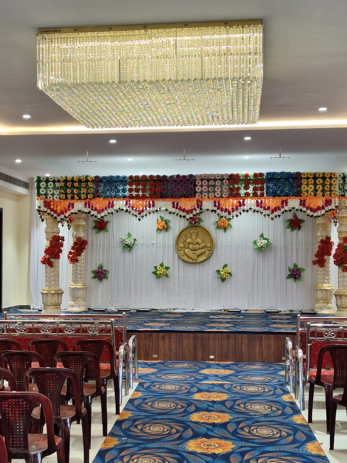 Stage decoration with Ganesh medallion and floral valance